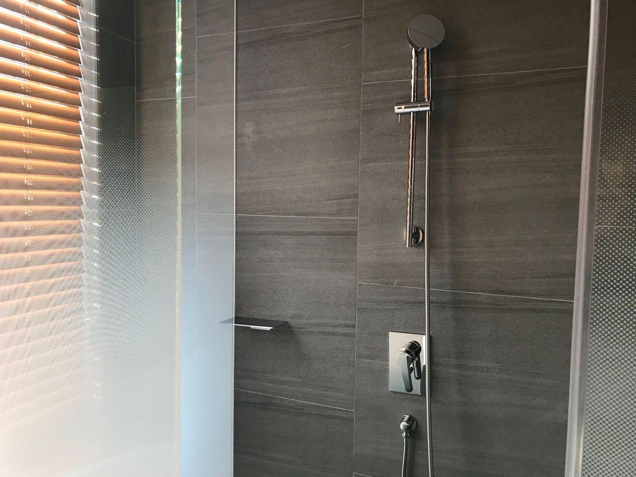 Contemporary shower area with a rainfall showerhead at Dongdaemun Novotel Ambassador Hotel.
